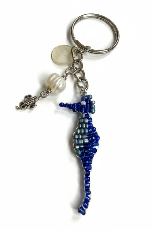 Silver keychain with beaded blue seahorse charm, silver baby turtle charm, accented with a freshwater pearl