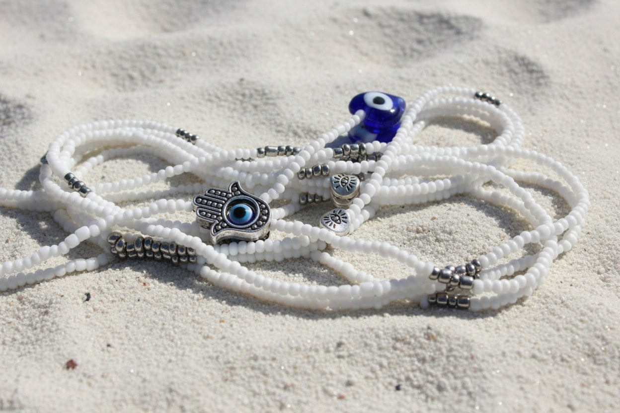 White waistbeads with evil eye hamsa hand and glass heart and accents of silver beads