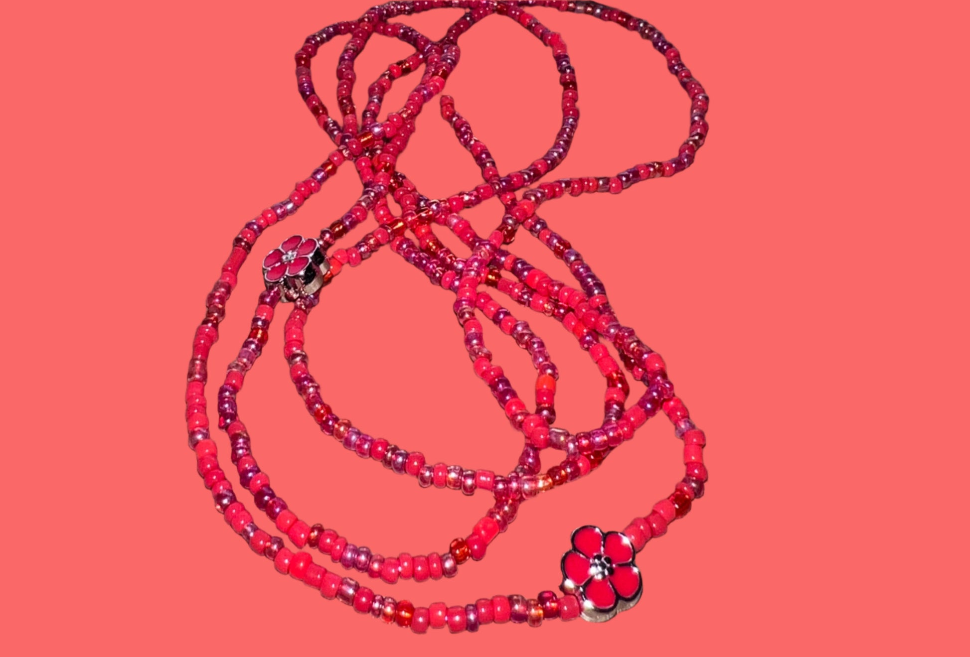 Red waistbeads on a wooden surface 