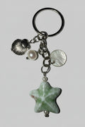 Silver keychain with star-shaped porcelain charm, shell, and pearl