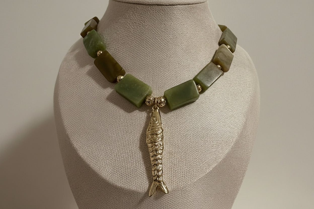 Necklace with green jade, gold nugget beads and a gold fish pendant 