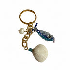 Gold keychain with shell, beaded fish charm, and pearl