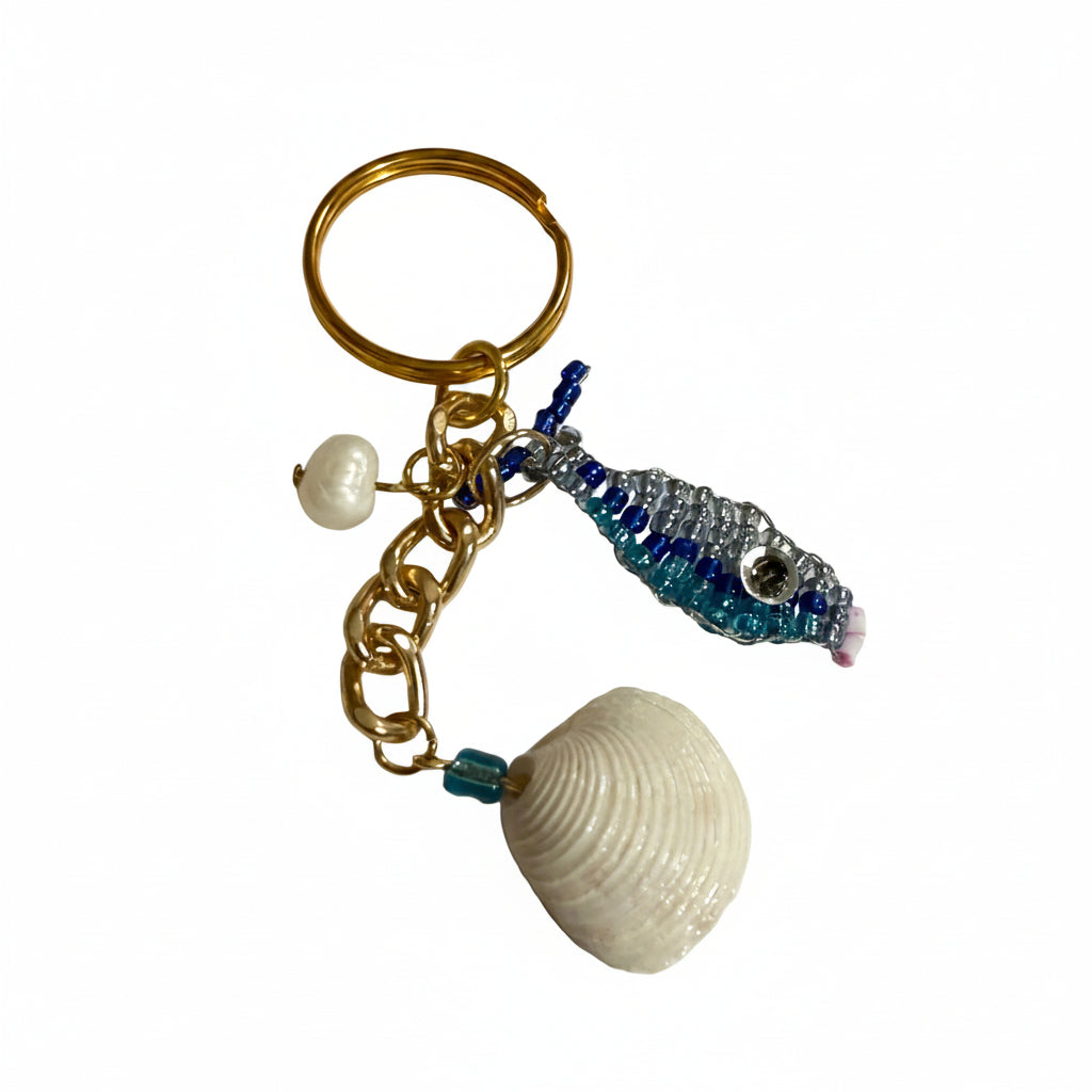 Gold keychain with shell, beaded fish charm, and pearl