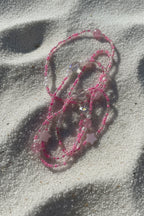 baby pink waistbeads made by gabi decor studio with pink stars, moonstone beads and pink reflective beads