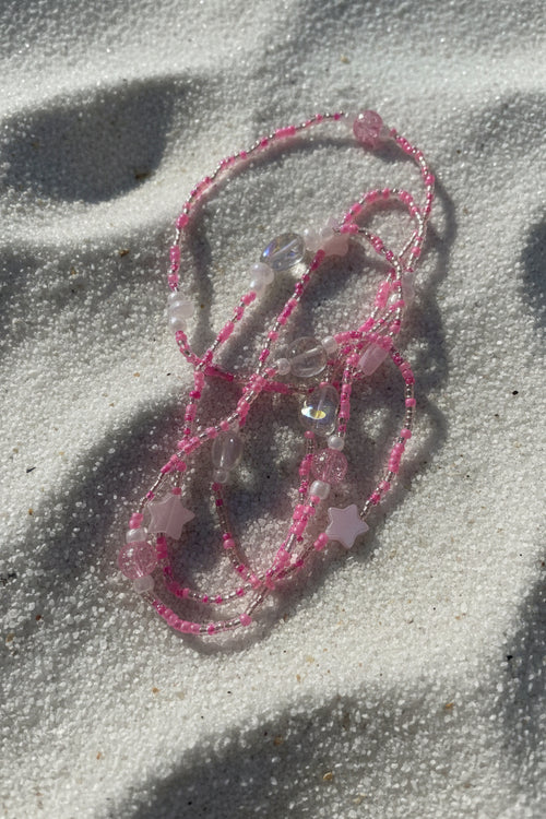 baby pink waistbeads made by gabi decor studio with pink stars, moonstone beads and pink reflective beads