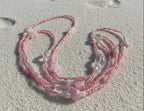 baby pink waistbeads made by gabi decor studio with pink stars, moonstone beads and pink reflective beads