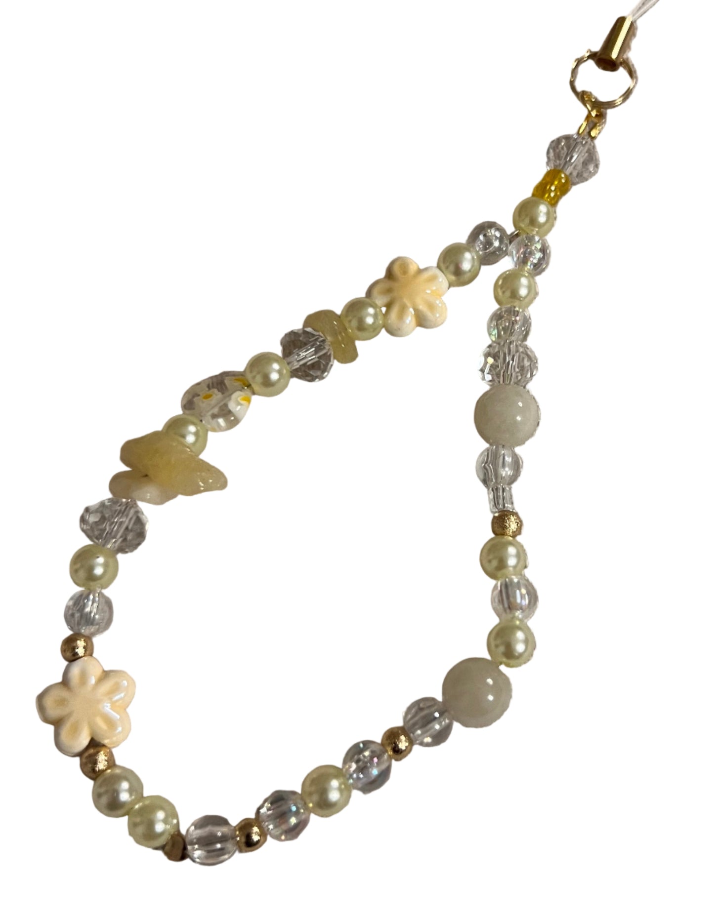 Beaded wristlet charm with flowers on a textured beige background