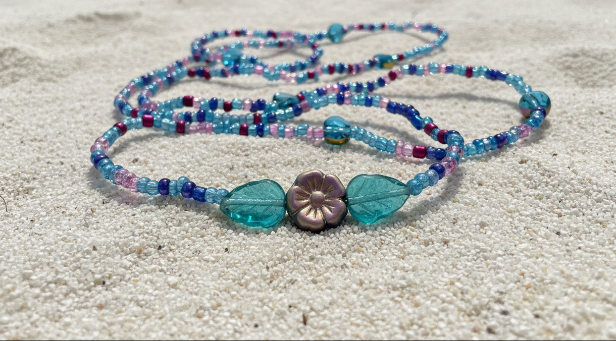 This set offers a beautiful blend of teal, purple, and blue beads. Accented with purple reflective flowers surrounded with leaves! So comfy, you won't even feel like you're wearing them!