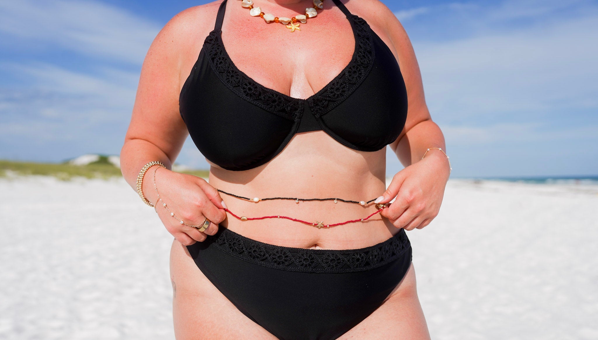 woman wearing a black bikini on a beach