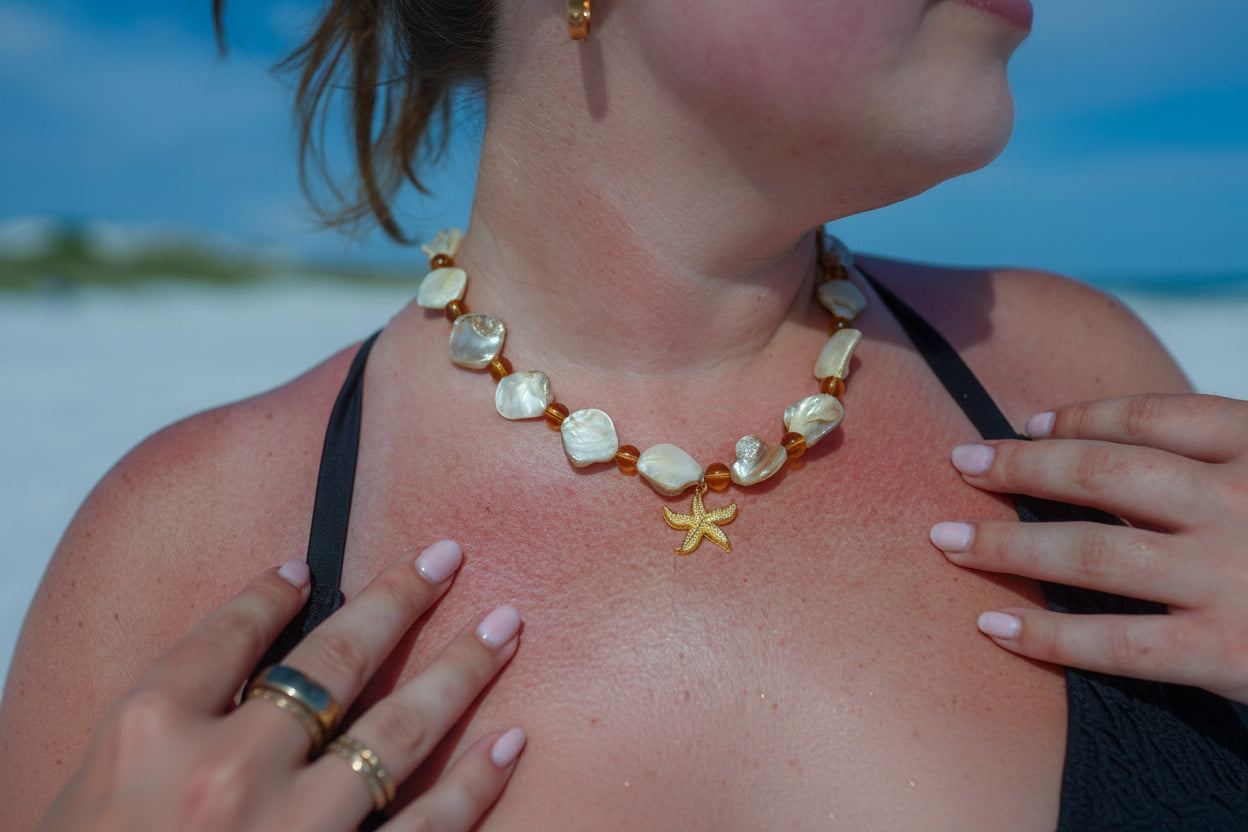woman wearing a necklace with a starfish pendant on a beach