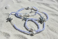 lila waist beads made with lilac colored seed beads adorned with starfish charms and pearl beads