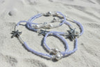 lila waist beads made with lilac colored seed beads adorned with starfish charms and pearl beads