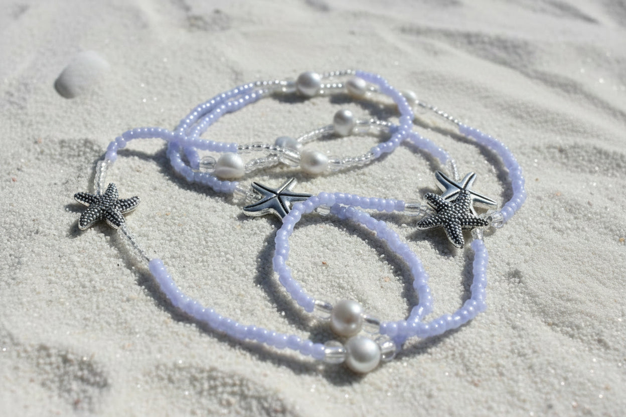 lila waist beads made with lilac colored seed beads adorned with starfish charms and pearl beads
