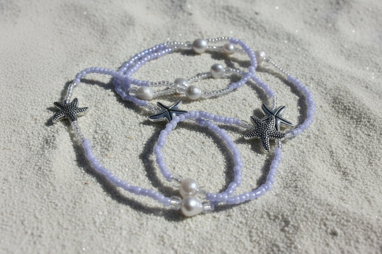 lila waist beads made with lilac colored seed beads adorned with starfish charms and pearl-like beads