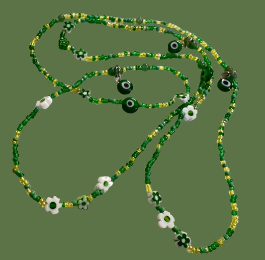 Green beaded wasitbeads with evil eye charms on a white background
