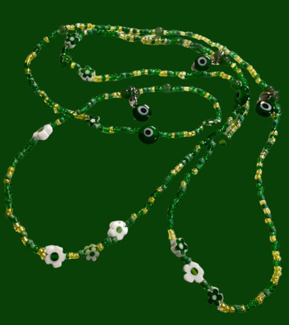 Green waistbeads with eye-shaped beads on a white background