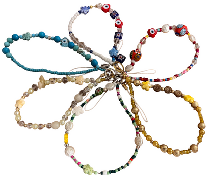 Colorful beaded wristlets on a wooden background