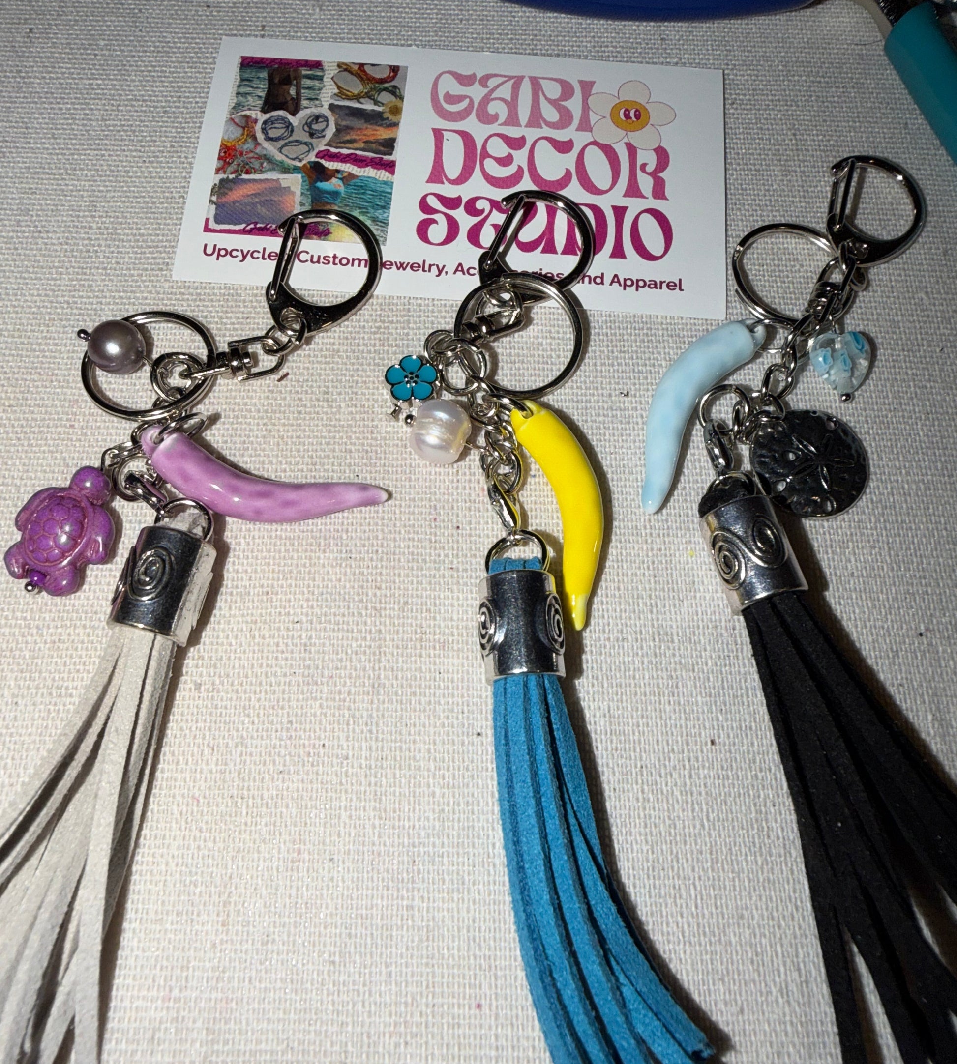 Keychains with tassels and charms. Grey, Blue, and Black purse charms