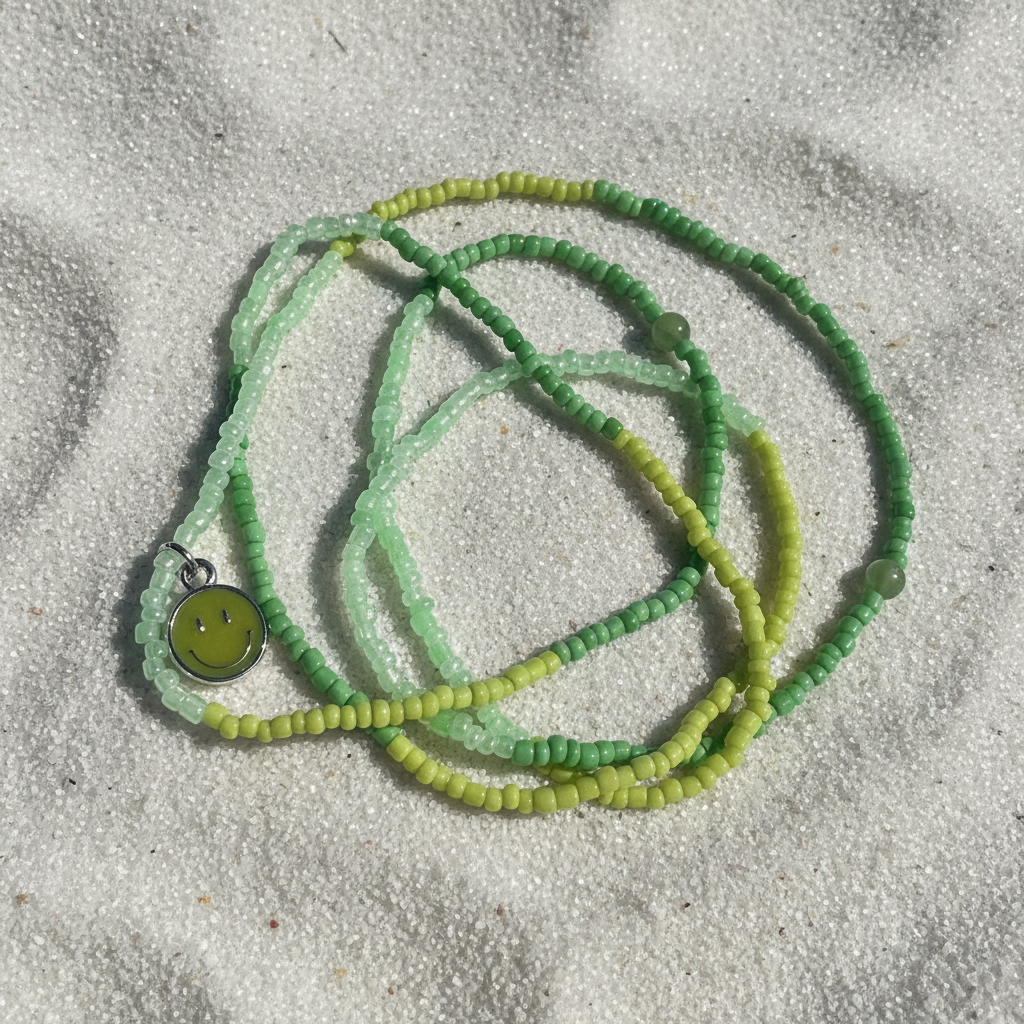 Green beaded waistbeads with a smiley face pendant