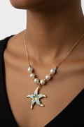 Gold necklace with a starfish pendant and pearls